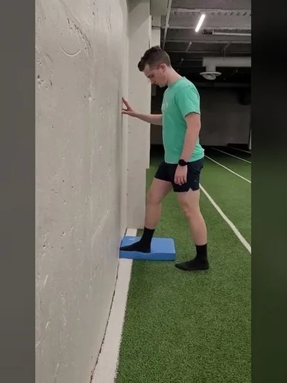 Knee to Wall Stretch on Block exercise demonstration