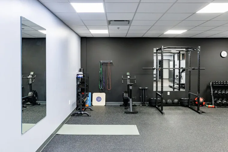 The strength and conditioning room with squat rack and platform