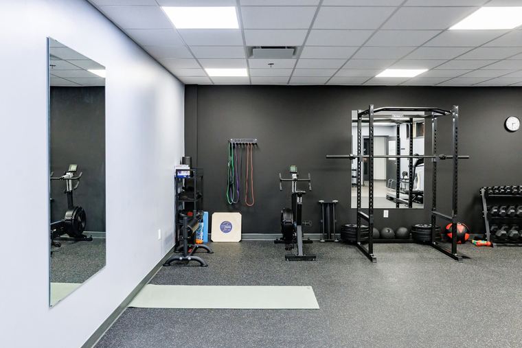 The strength and conditioning room with squat rack and platform
